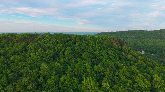 Summer aerial view featuring Chauncey Peak at Doctor Francis Giuffrida Park and the Bradley Hubbard Reservoir in Meriden, Connecticut just before sunset