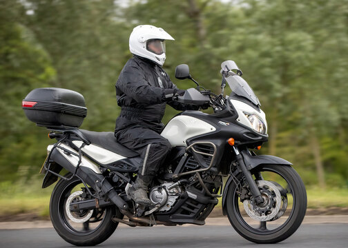 Stony Stratford,Bucks,UK - June 7th 2026:  Man riding a  2012 Suzuki DL 650 AL2  motorcycle driving on a British road