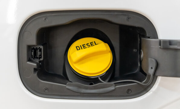 Diesel car concept. Open car fuel tank cap with the word diesel. The neck of the fuel tank of car for refueling with diesel fuel. An open fuel tank cap of a car for diesel fuel into the gas tank.