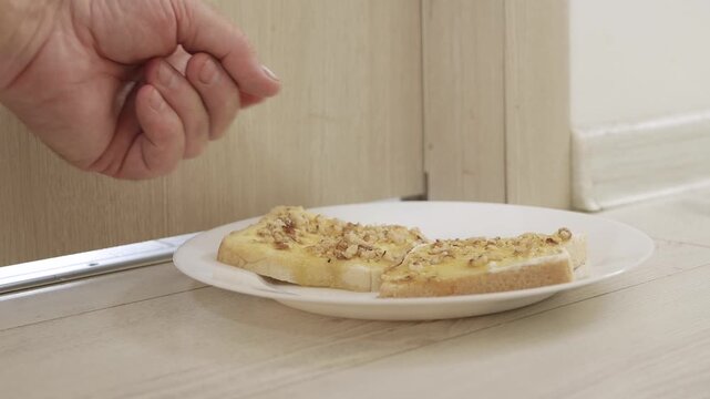 Putting in Front of the Door a Plate with Toast Spread, Butter, Cheese, Honey and Nuts for a Hungry Person. Food Delivered in Front of the Door.