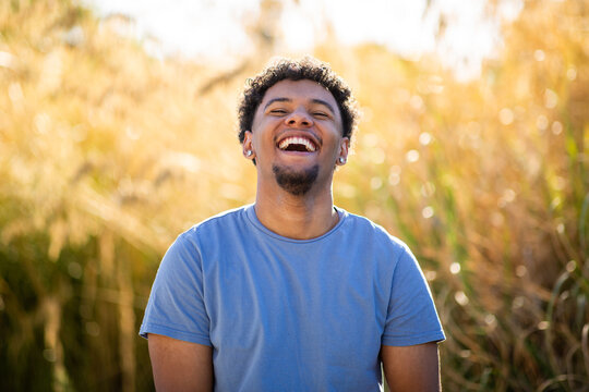 Portrait of laughing young man in sunlight