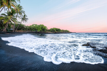 Peaceful Sunset on a Black Sand Volcanic Beach with Palm Trees and Pink Sky, Punaluu, Big Island, Hawaii, USA © EyesTravelling