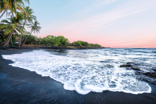 Peaceful Sunset on a Black Sand Volcanic Beach with Palm Trees and Pink Sky, Punaluu, Big Island, Hawaii, USA