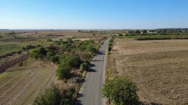 Panoramic Drone Shot Over Summer Farmland. Stunning Drone Aerial of Cultivated Fields and Green Vegetation.