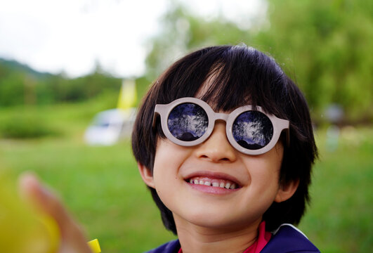 A portrait of a Chinese boy wearing cute sunglasses