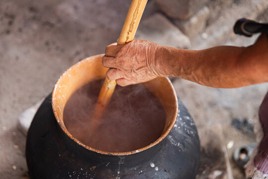 Stirring corn atole in Boiling Pot
