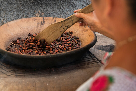 Roasting cacao Beans on Traditional comal in Mexico