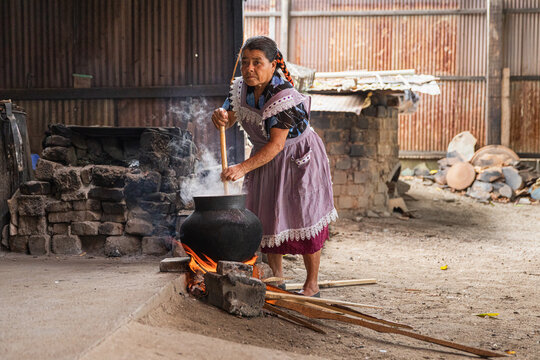 Woman Cooking in Rustic Village Environment