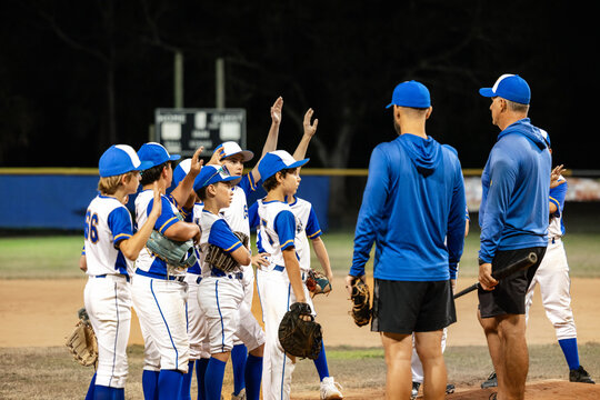 Coach Gives Team Talk During Baseball Game