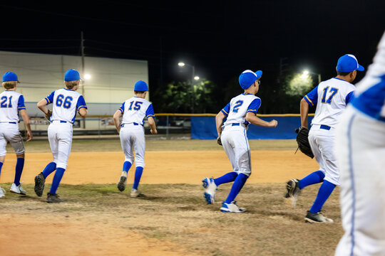 Young Baseball Team Practices at Night on the Field
