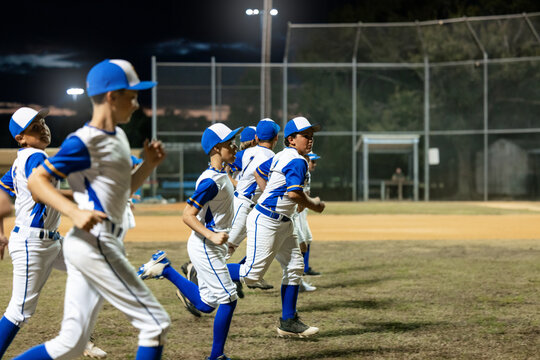 Players Train on Field at Night