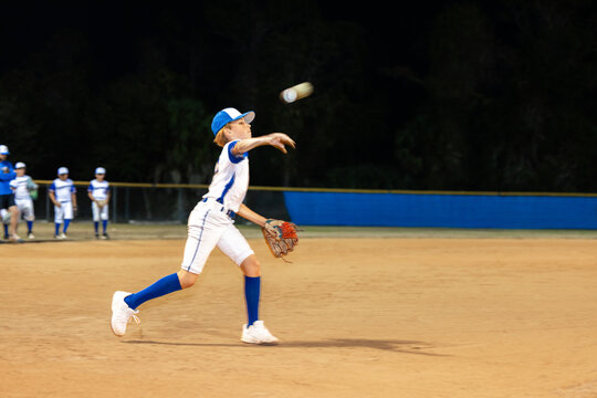 Nighttime Baseball Fielder Throws Ball in Uniform