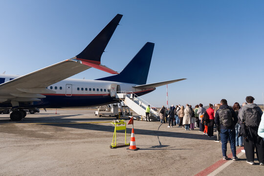 People Boarding a Flight at the Airport 