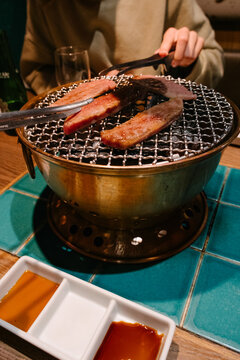 Grilling beef in a yakiniku restaurant in Japan.