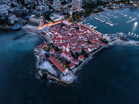 Budva old town in Montenegro, evening city light. Drone shot