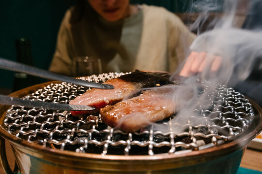 Grilling meat in a yakiniku reastaurant