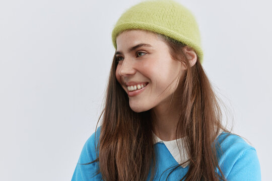 Studio portrait of happy woman in colorful hat