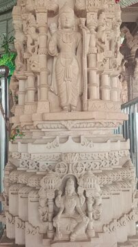 Intricate stone carving of Lord Rama and Goddess Sita on a traditional Hindu temple pillar