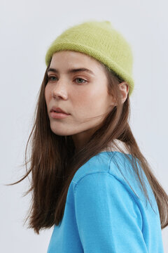 Portrait cool woman in colorful hat over white background