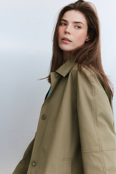 Portrait of Woman in Trench Coat Looking Back