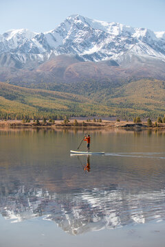 Paddleboarder on a mountain lake

