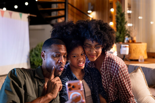Family taking a selfie with silly faces