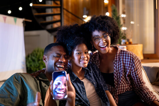 Family video calls with a smiling face on the screen.