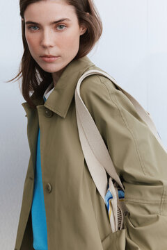Fashion portrait of woman with tote bag looking at camera