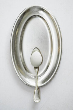 Metal Platter With a Spoon Placed in the Center