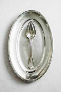 Silver Plate and Spoon on White Background With No Food Present