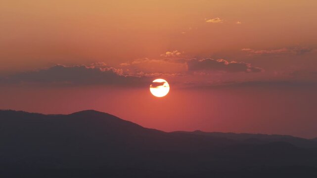 Beautiful Landscape with a Red Sunset in a Mountain Dusk. Alpine Sunset View with Clouds on the Sky. Beautiful Red Sunset on the Mountainous Landscape.