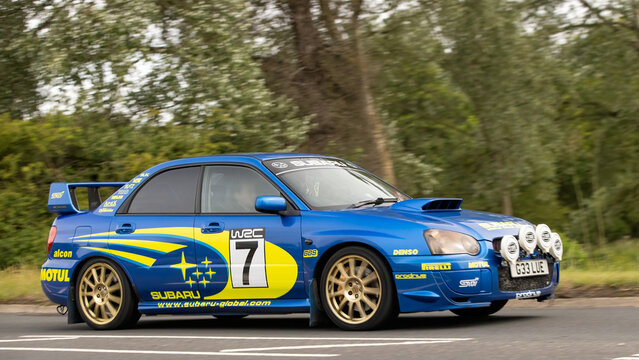 Stony Stratford,Bucks,UK - June 7th 2026: Blue  2003 Subaru Impreza WRX STI rally car car driving on a British road