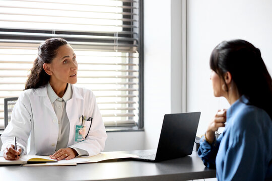 Doctor Talks With Patient in Hospital Office Room