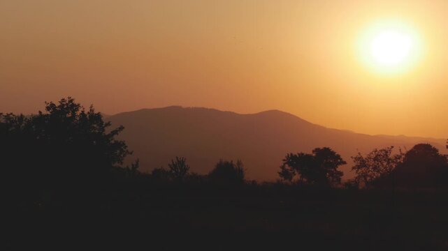 Beautiful Landscape with a Red Sunset in a Mountain Dusk. Alpine Sunset View with Clouds on the Sky. Beautiful Red Sunset on the Mountainous Landscape.