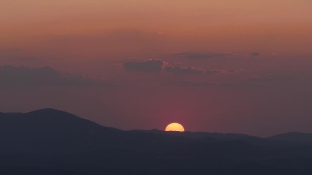 Beautiful Landscape with a Red Sunset in a Mountain Dusk. Alpine Sunset View with Clouds on the Sky. Beautiful Red Sunset on the Mountainous Landscape.