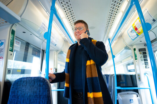 Talking on phone inside train carriage