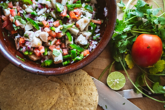 Fresh ceviche with vegetables herbs and tortillas