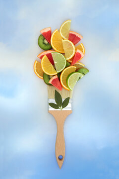 Painting with tropical citrus fruit paintbrush surreal food art design. Summer fun fruits abstract high in antioxidants, vitamin c on blue sky background.