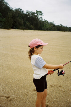 Young Girl Holding Fishing Rod on Tropical Queensland Beach