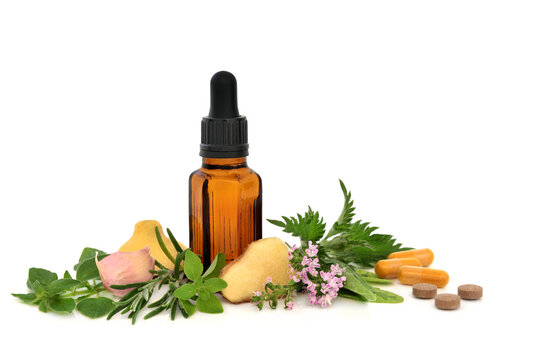 Herbal medicine for sneezing hay fever allergies, anti histamine treatment with herbs fruit and pharmaceutical pills and capsules on white, brown tincture bottle. 