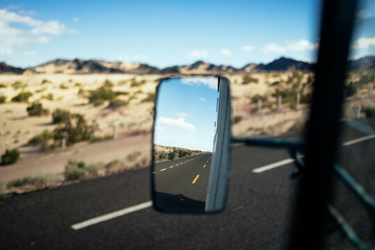 Side mirror reflection of a highway