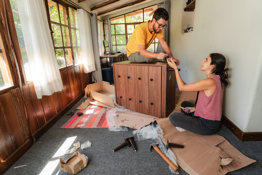 young couple Assembling Wooden Furniture at Home