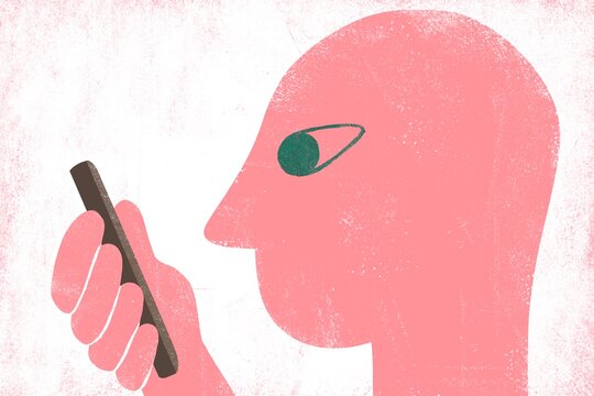 Human head looking into the mobile phone