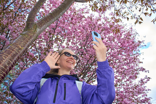 Low angle shot of woman taking selfie with smartphone