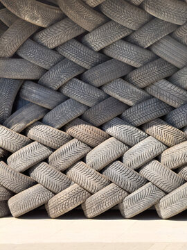 Stacked Old Car Tires for Recycling and Industrial Texture