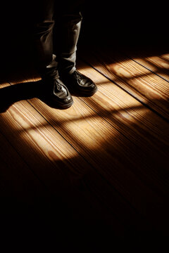 Light and Shadow Play on Floor With Standing Shoes at Midday