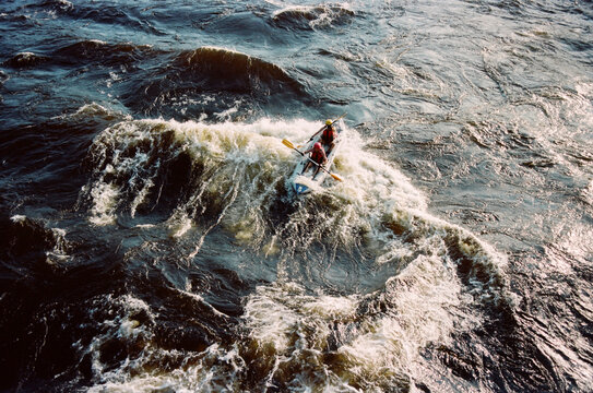 Kayakers navigate the river in bright sunlight