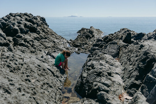Child Exploring Rockpool, Eimeo Queensland