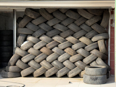 Stacked Old Car Tires for Recycling and Industrial Texture