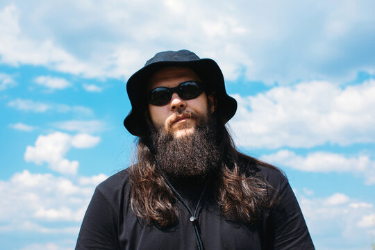 Stylish bearded man in sunglasses and panama 
